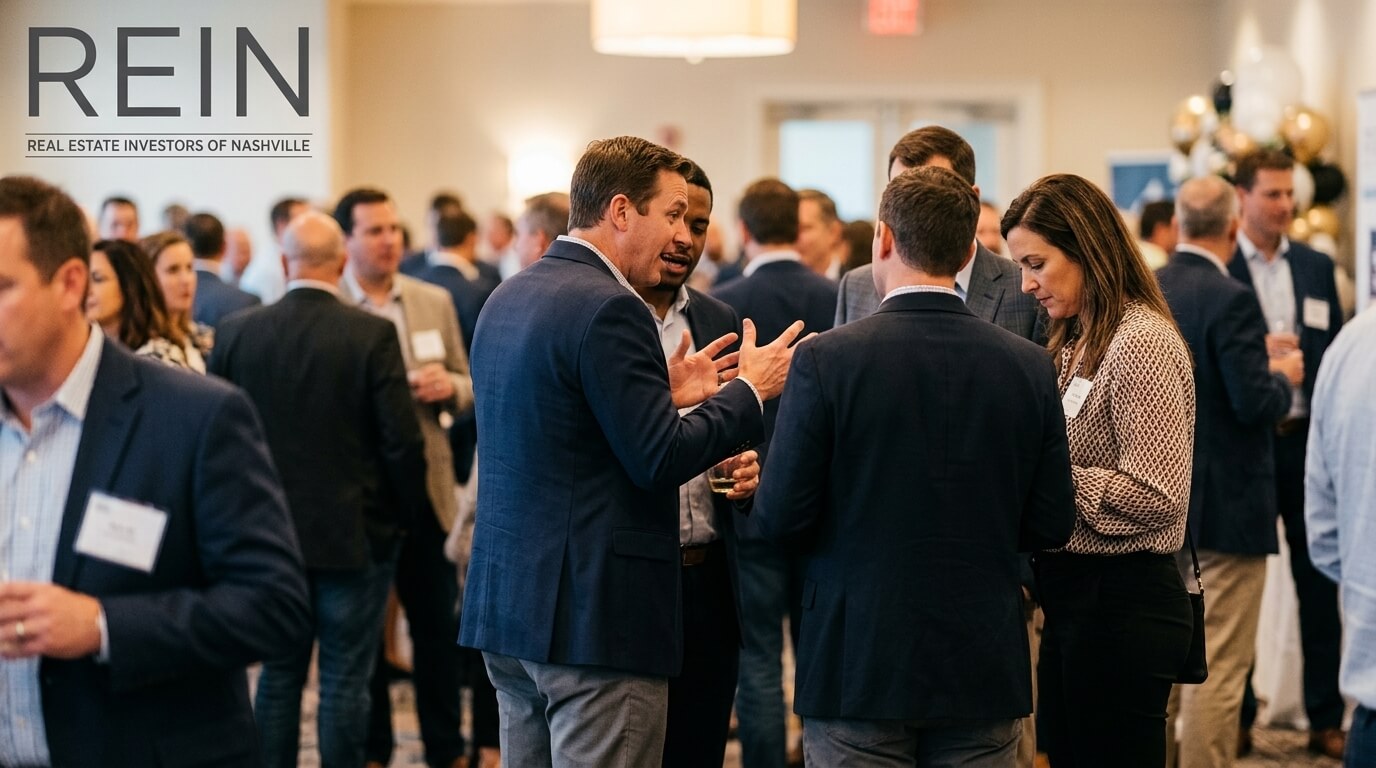 Real estate investors having a focused conversation at a Nashville networking event